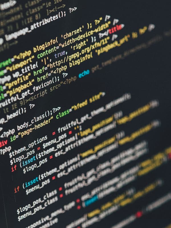 Close-up of source code displayed on a dark monitor