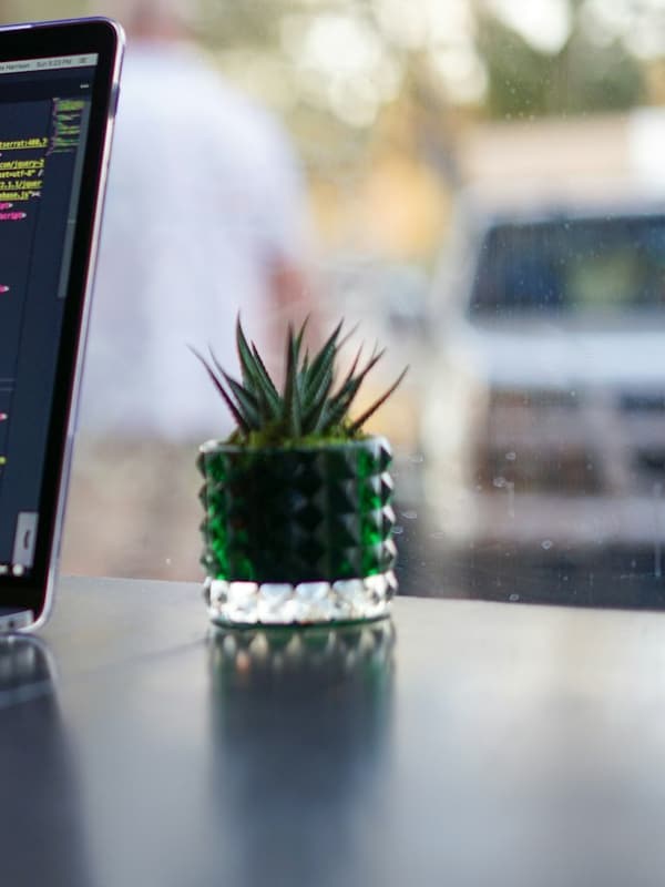 A laptop on a desk showing code in an editor